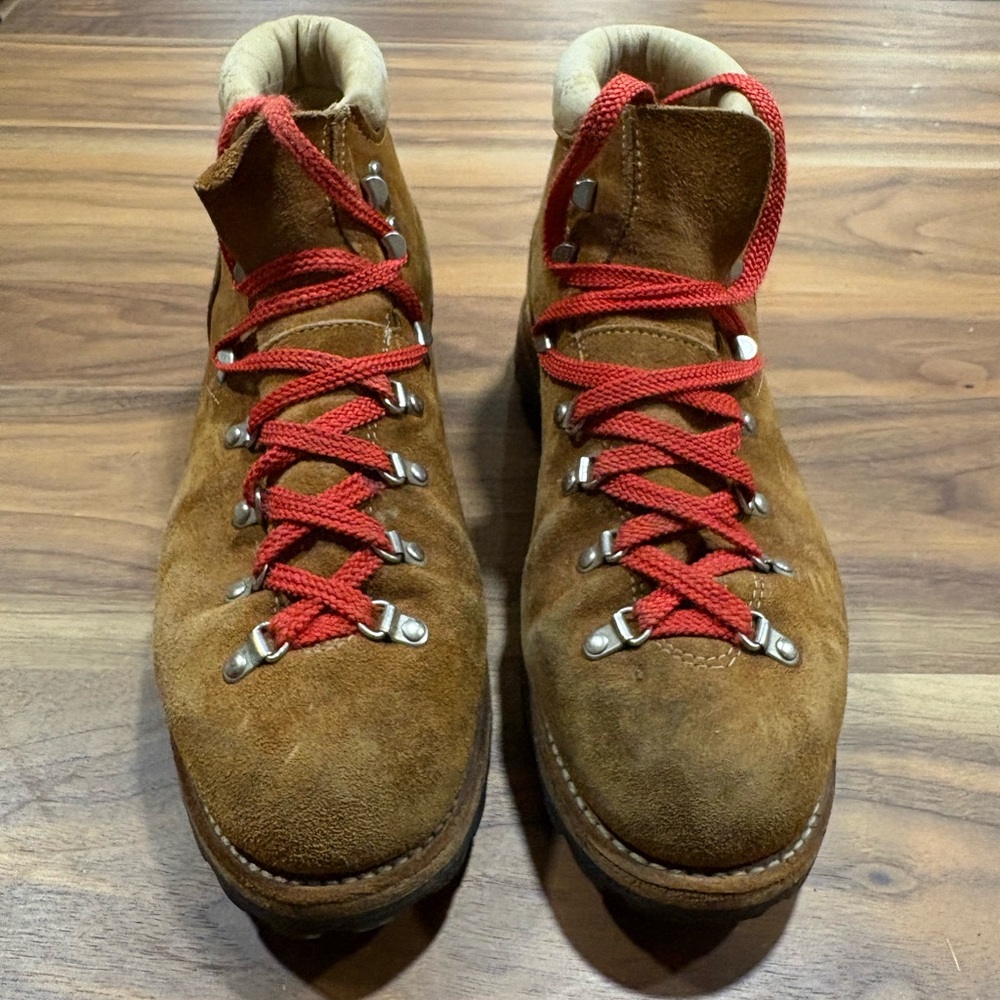 Vintage hiking boots with red laces and vibram sole.